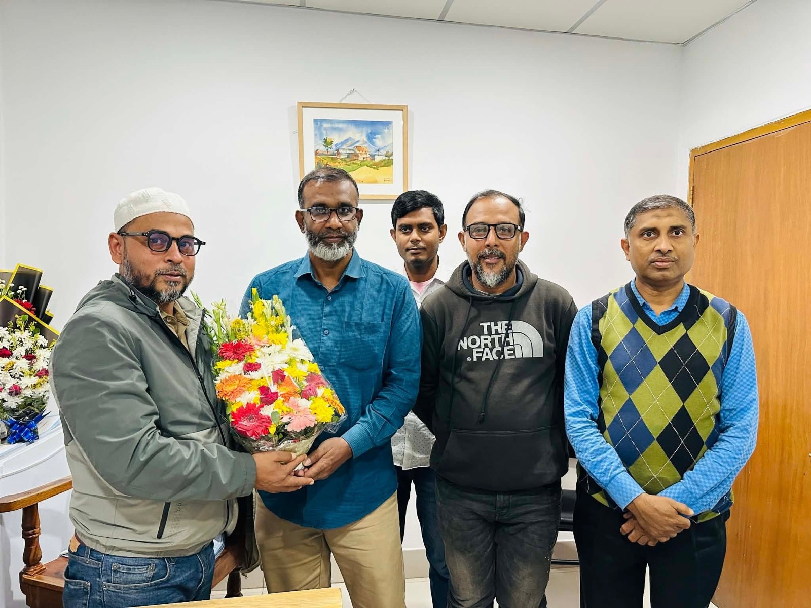 The Spandan family presenting floral greetings to Dr. Gias Uddin Ahmed
