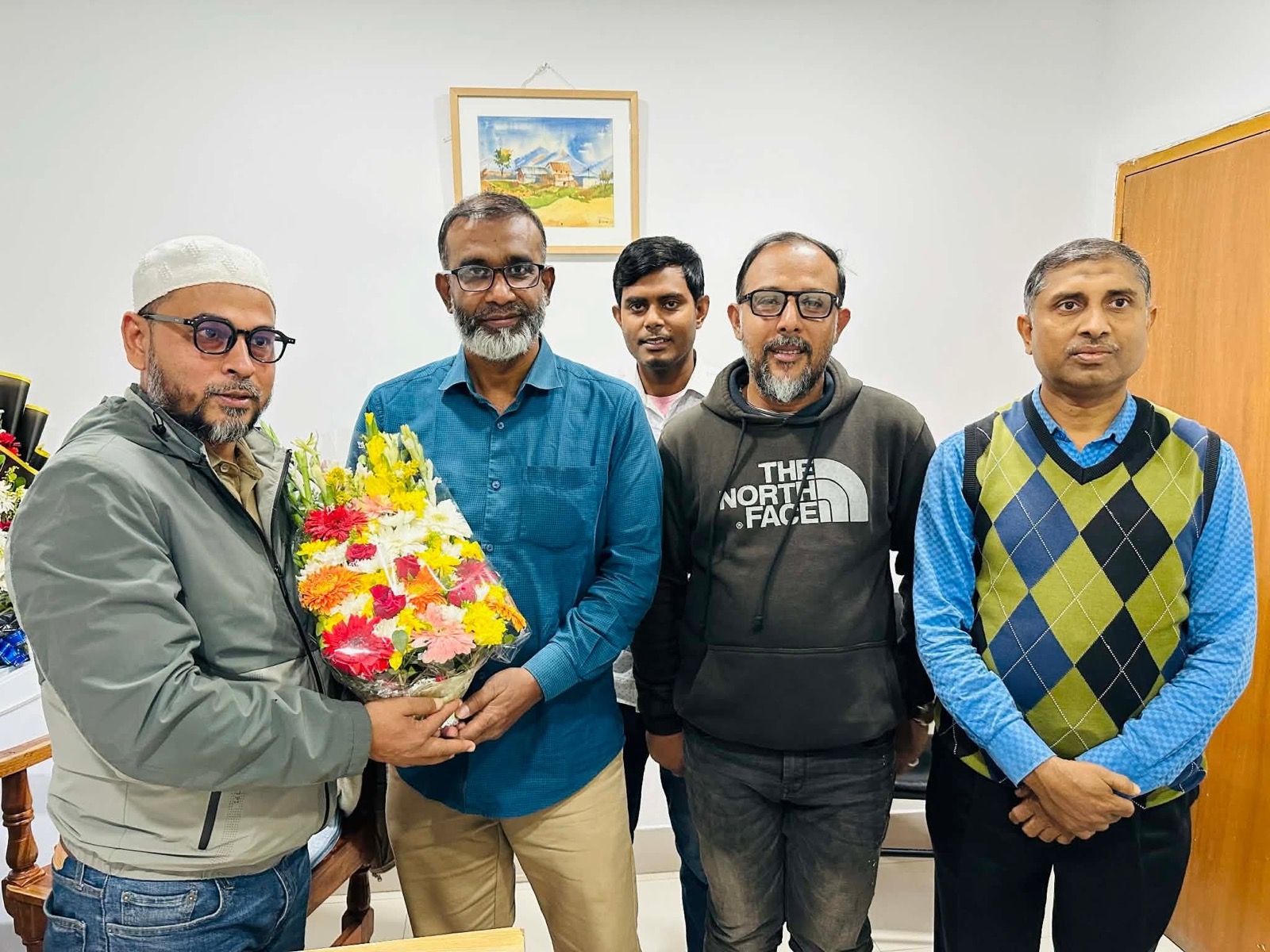 The Spandan family presenting floral greetings to Dr. Gias Uddin Ahmed
