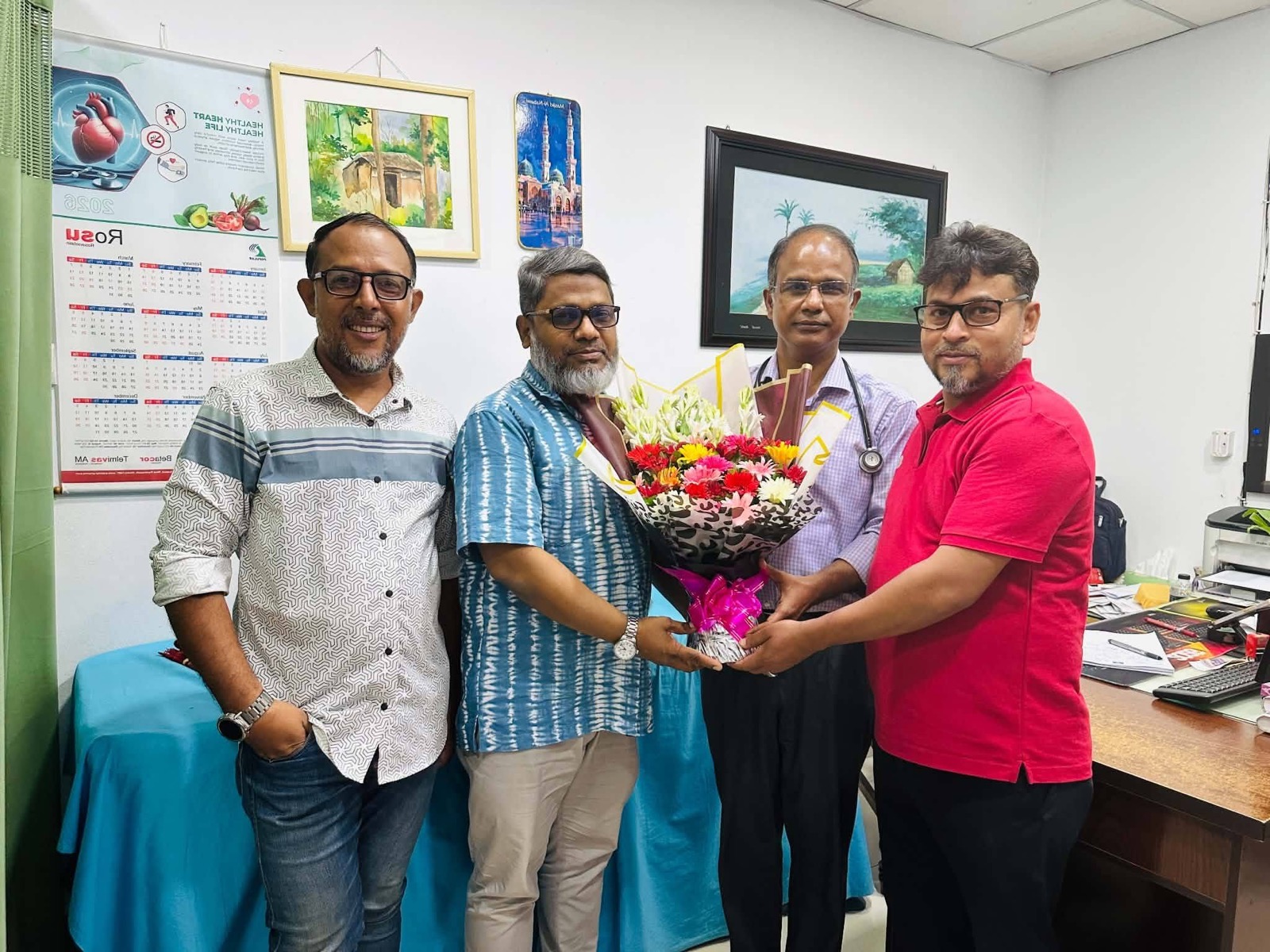 The Spandan family presenting floral greetings to Dr. Kamal Uddin Ahmed