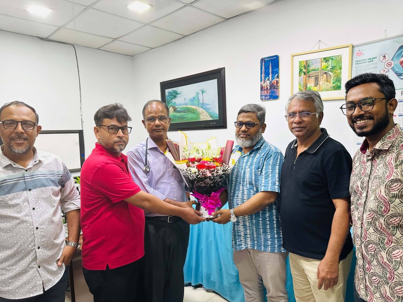 The Spandan family presenting floral greetings to Dr. Kamal Uddin Ahmed