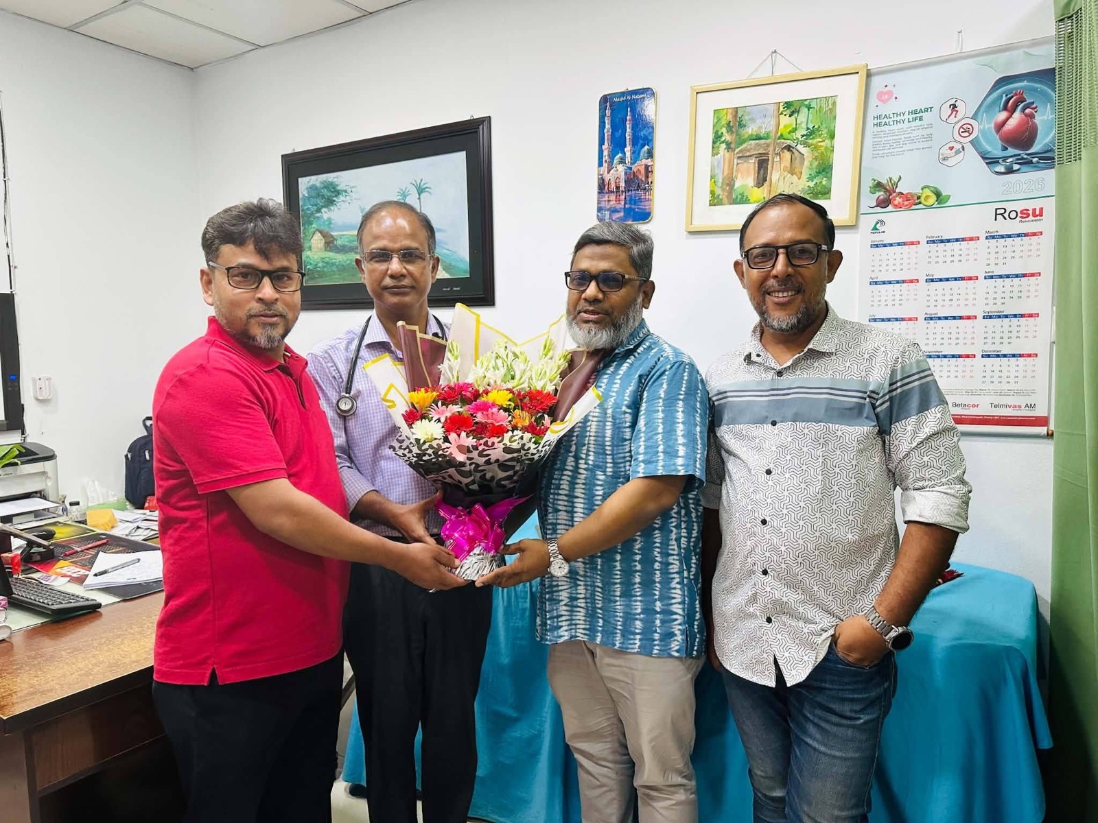 The Spandan family presenting floral greetings to Dr. Kamal Uddin Ahmed